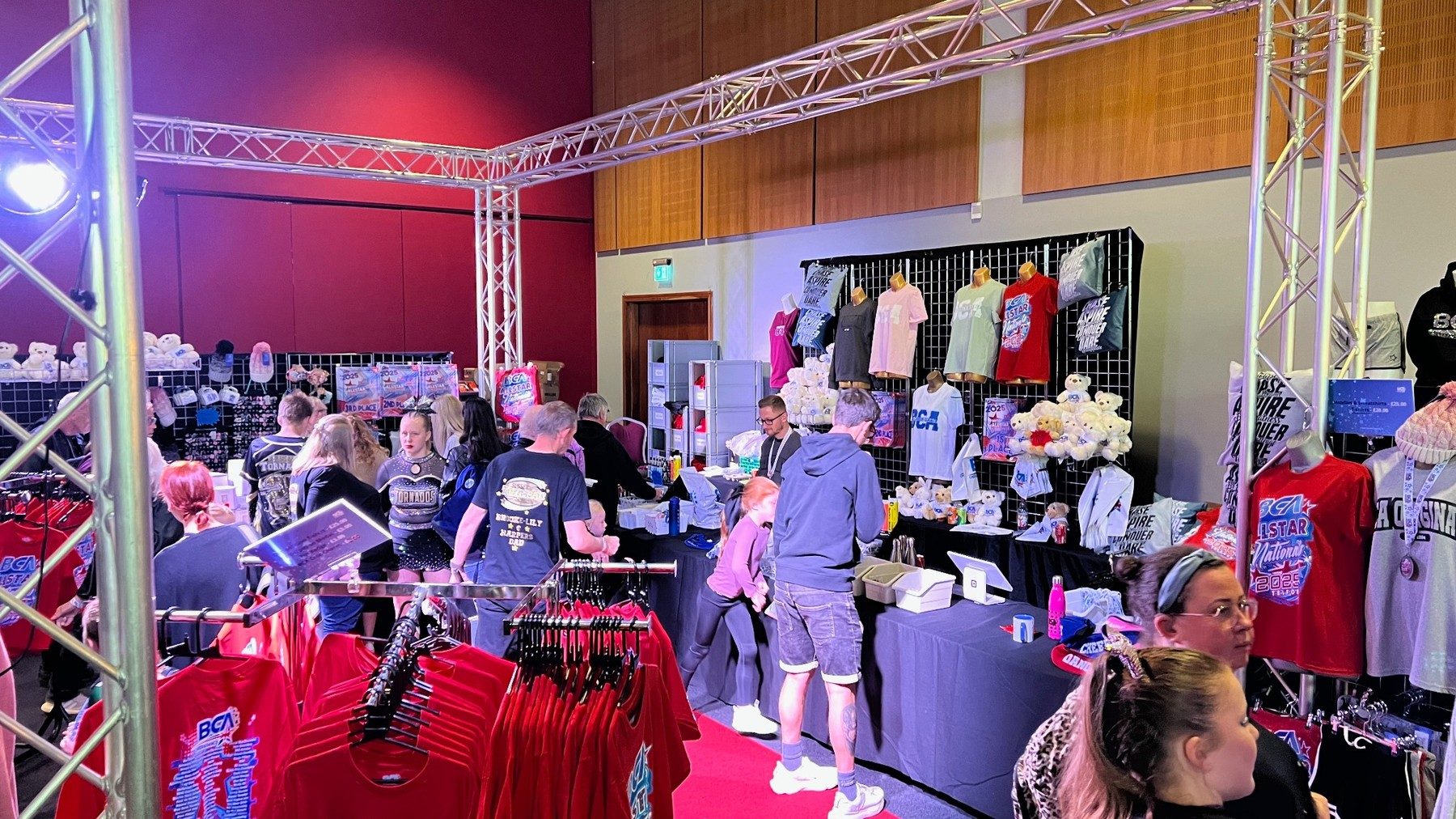 Busy temporary retail environment supported by truss and event lighting